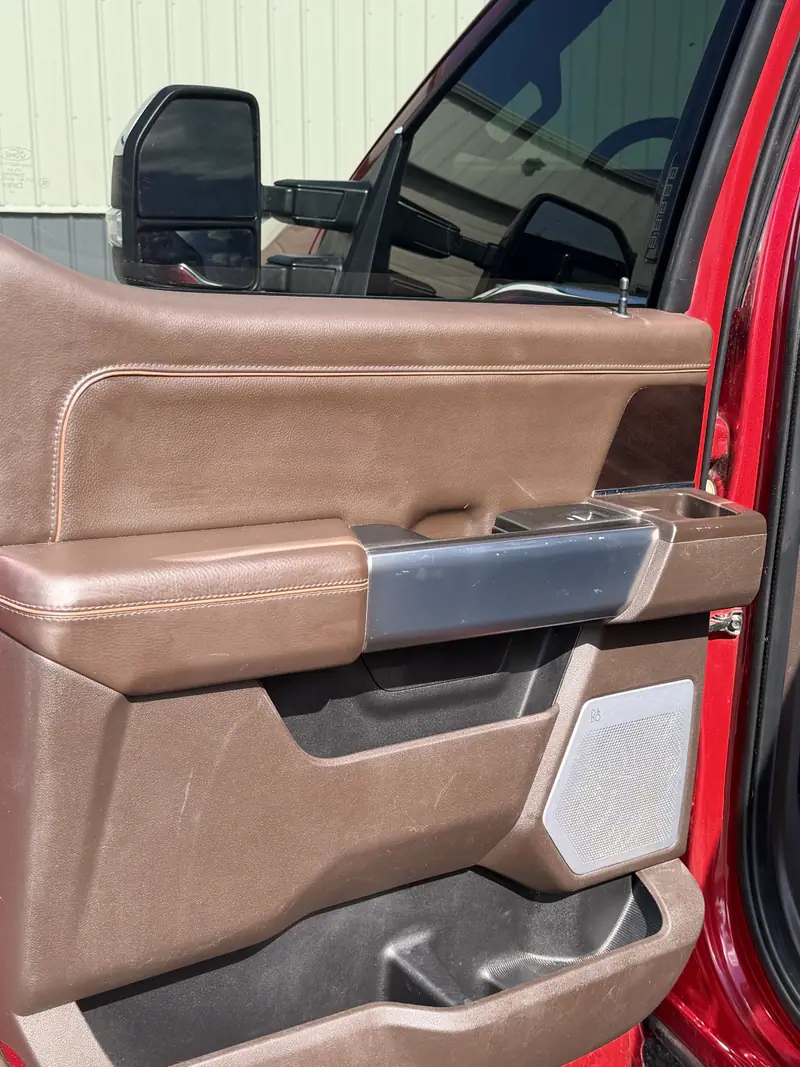 Close-up of a brown leather door panel and pocket after detailing