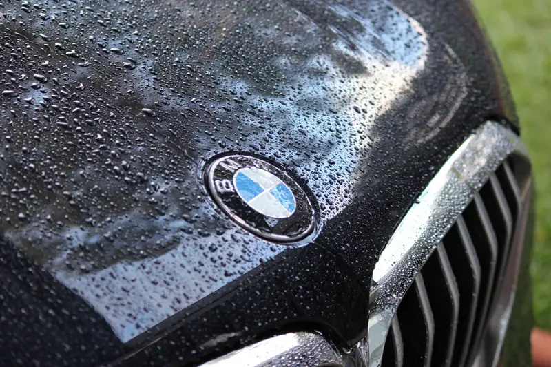 Water beads sitting on a waxed hood