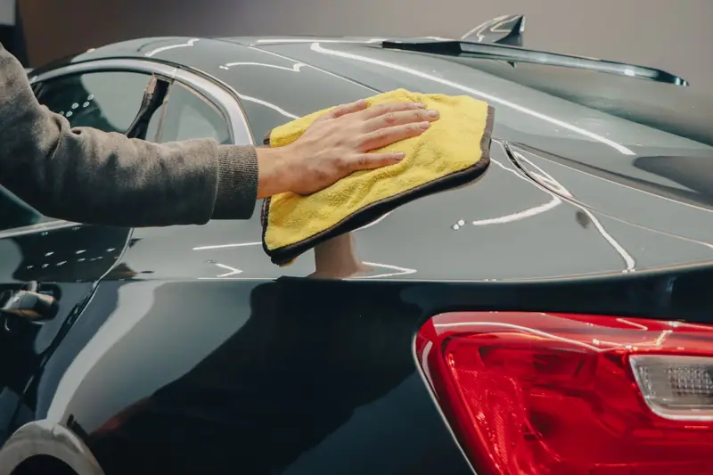 Drying car paint with a soft yellow microfibre towel