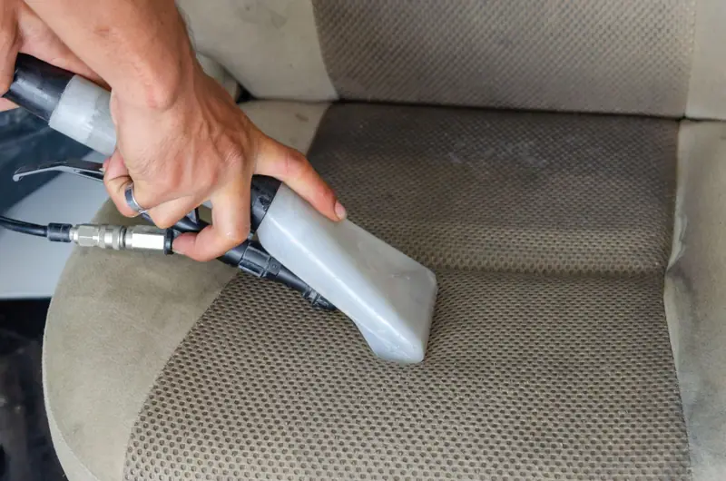 Upholstery tool cleaning a cloth car seat