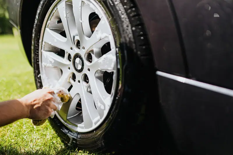 Cleaning a wheel by hand during a detail